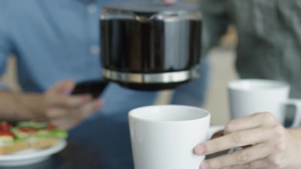 Close-up of a Woman Pouring Coffee from Coffee Pot for Two. - Filmati, video