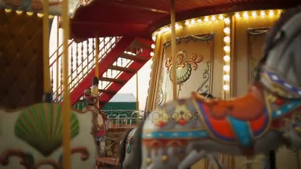 Horse rides on vintage merry-go-round carousel at fair - Footage, Video