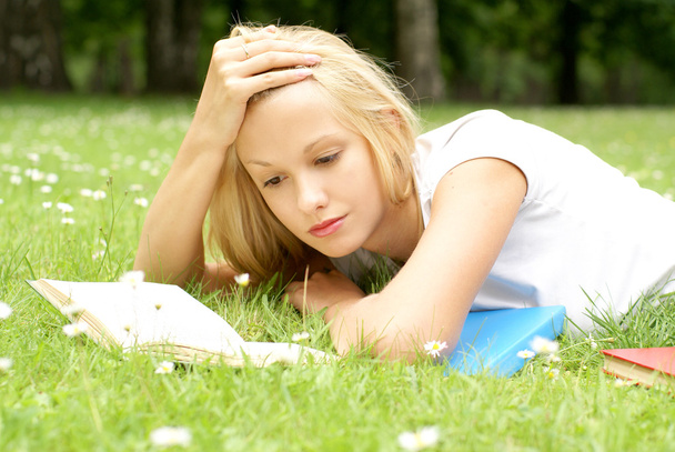Young beautiful girl reading - 写真・画像