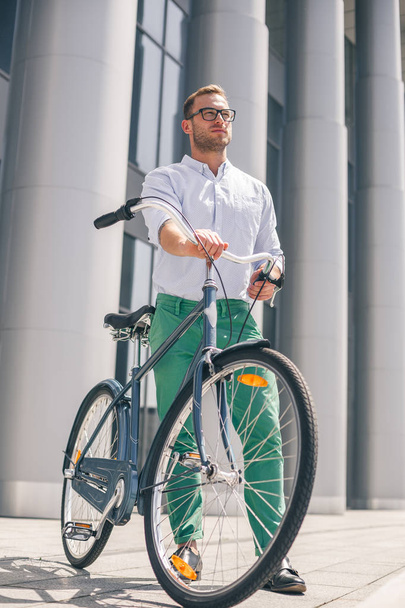 Cool young bearded hipster with bicycle on the city street. - Φωτογραφία, εικόνα