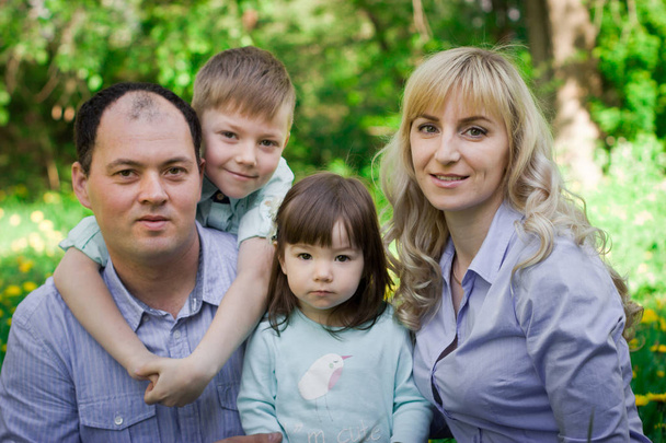 Family portrait in a spring park.  - Foto, Imagem