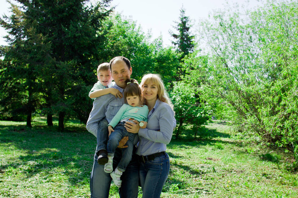 Portrait of a family of four outdoors.  - Fotoğraf, Görsel