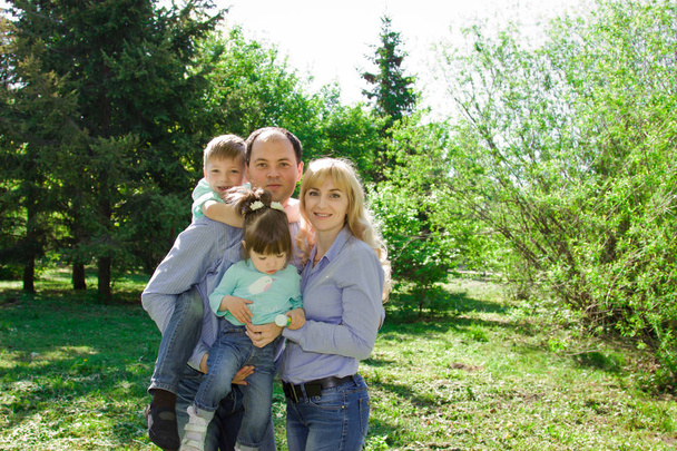 Portrait of a family of four outdoors.  - Fotó, kép