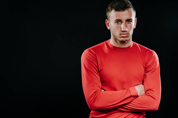 Handsome man wearing red sportswear and posing after exercises on dark background. Healthy inspirational fitness lifestyle, sport motivation. - Zdjęcie, obraz
