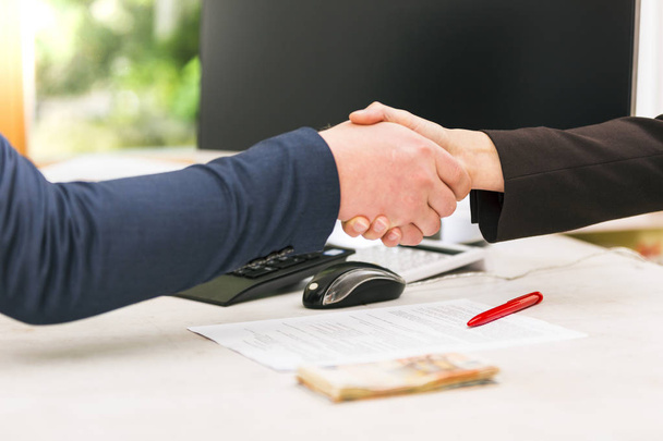 Handshake of business partners after agreement. successful loan  - 写真・画像