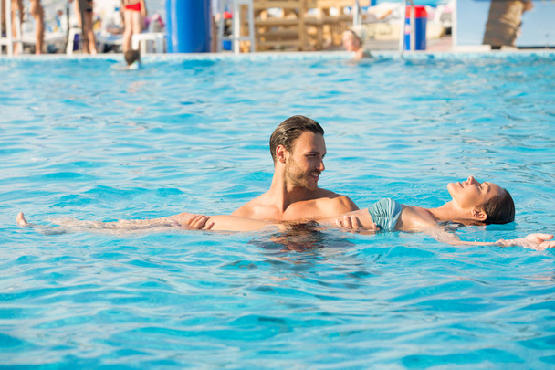 Affectionate couple in swimming pool  - Valokuva, kuva
