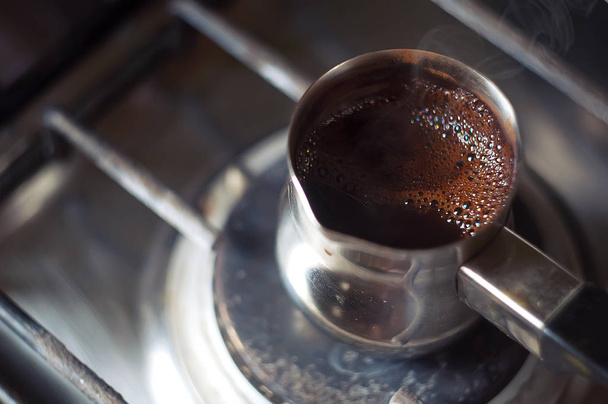 coffee Turk with the foam boiling on the stove - Φωτογραφία, εικόνα
