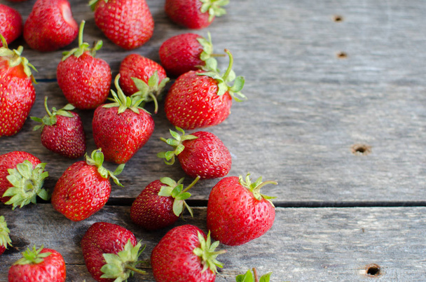 Strawberries on old wooden background - Foto, Imagen