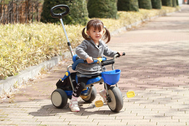 Japanese girl riding on the tricycle (2 years old) - Photo, Image