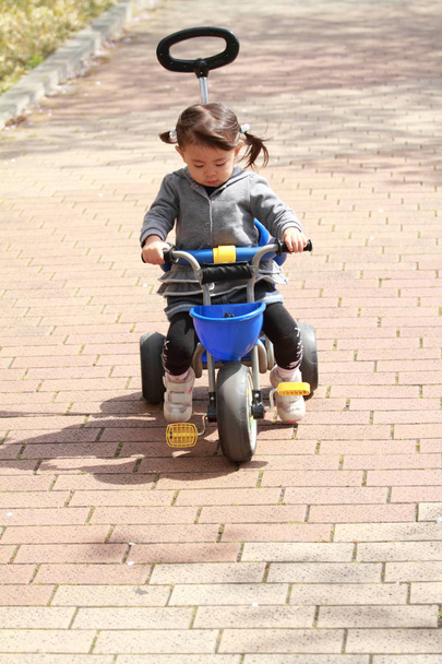 Japanese girl riding on the tricycle (2 years old) - Photo, Image