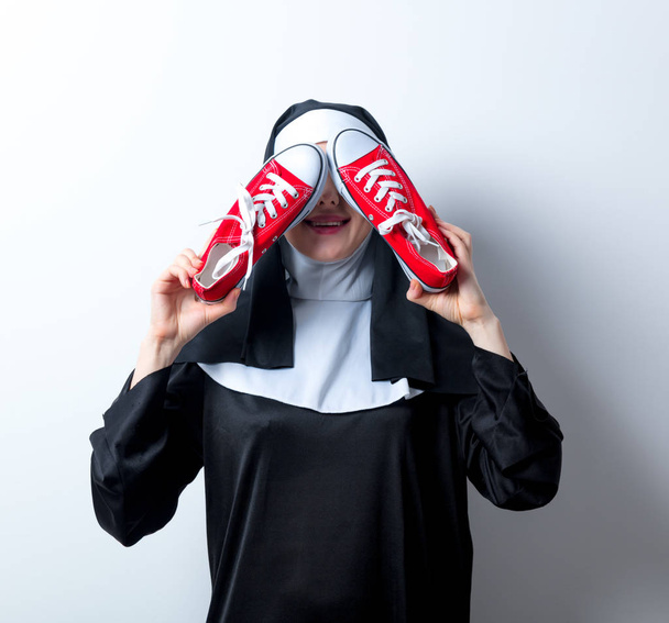 nun with red gumshoes - 写真・画像