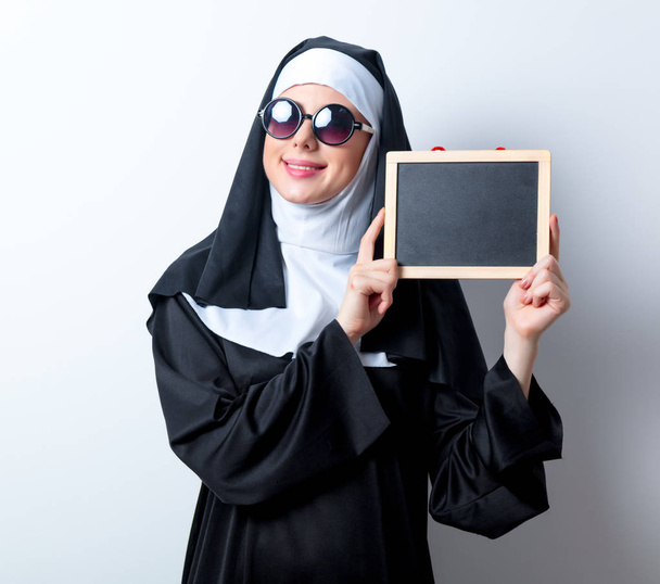 Young smiling nun with board  - Foto, Bild