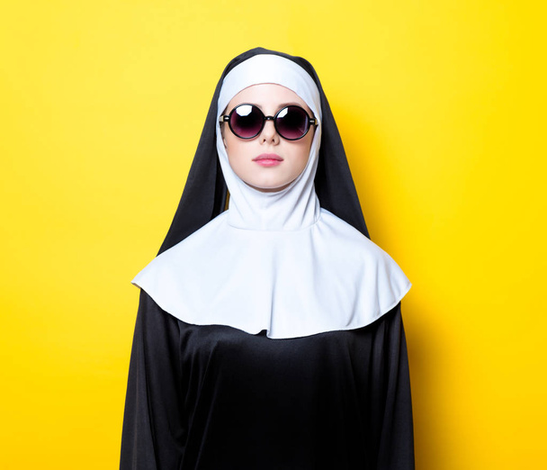 Young nun with sunglasses - 写真・画像