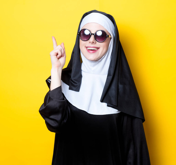 Young happy nun with sunglasses - 写真・画像