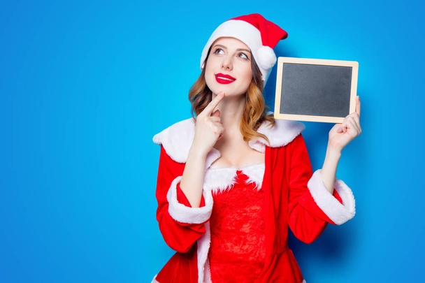 Santa  girl in red clothes with board  - Foto, Imagen