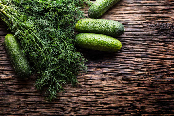 Cucumber and dill on very old rustic oak table - Photo, image