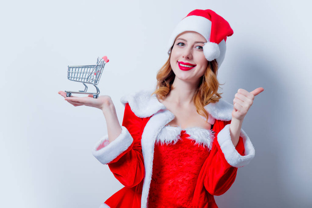 Santa girl with shopping cart - Foto, imagen