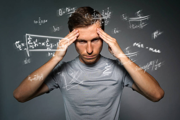 Man scientist or student working with various high school maths and science formulas. - Foto, Imagem