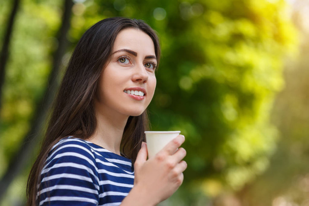 woman holding disposable cup of coffee - Photo, image