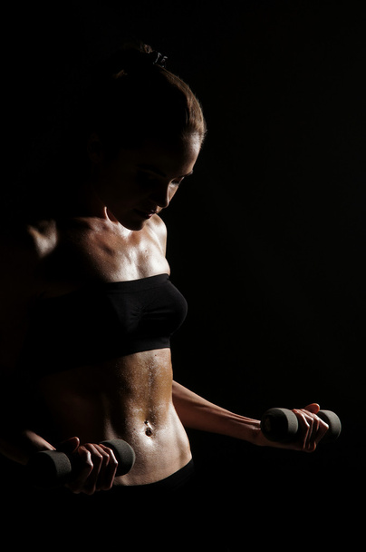 Sporty belly over dark background - Valokuva, kuva