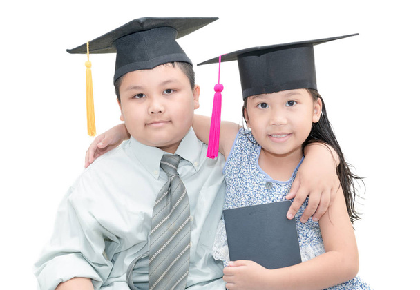 handsome boy and cute girl with graduate cap  - Photo, Image