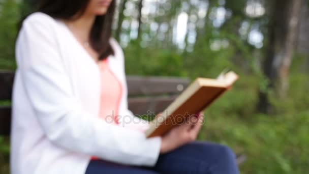 Woman with old book in the park. Slide slider - Πλάνα, βίντεο