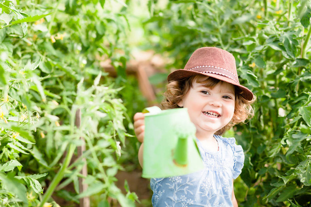Cute toddler gardener in the greenhouse - Фото, зображення
