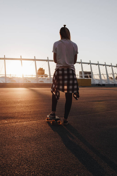 Hipster girl with skate board - Fotó, kép