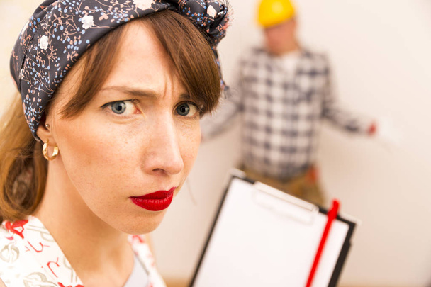 Angry housewife giving orders to handyman for house chores - Photo, Image