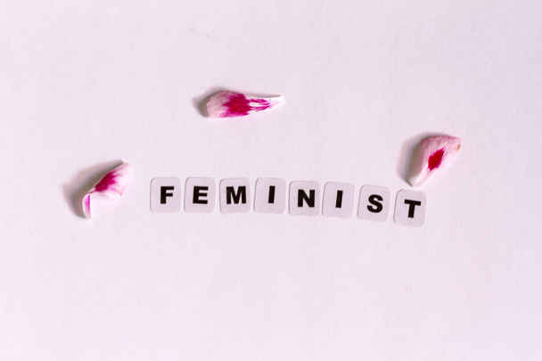Feminist word written in black letters  - Φωτογραφία, εικόνα