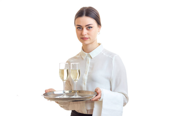 beautiful young waitress holding wine glasses on a tray that - Photo, Image