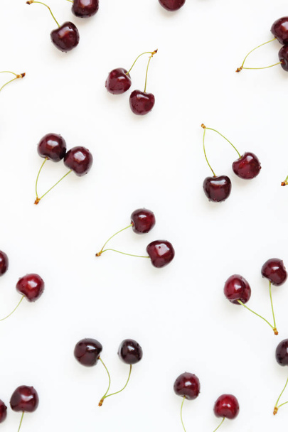 Fresh cherry berries are scattered on a white background. Concep - Foto, imagen