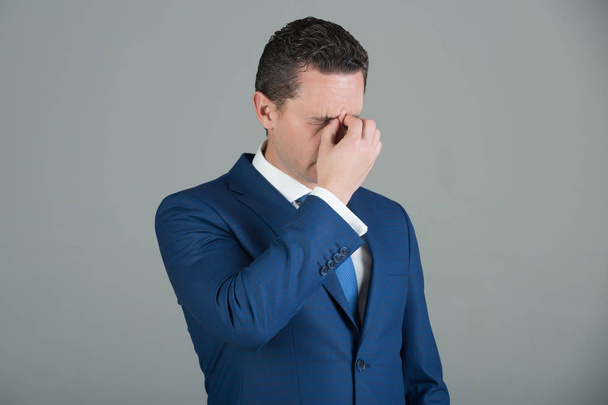 Tired man feeling headache in blue suit - Foto, imagen
