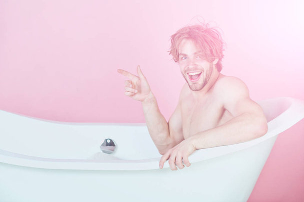 guy or happy man with muscular body sitting in bathtub - Photo, Image