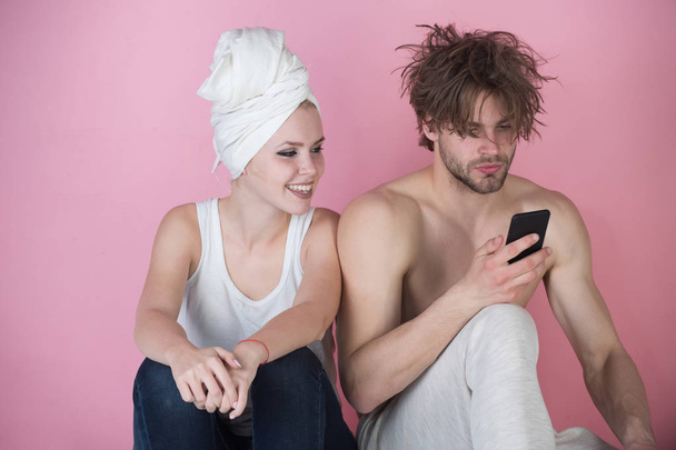 couple in love, man and woman on bathtub with phone - Фото, изображение