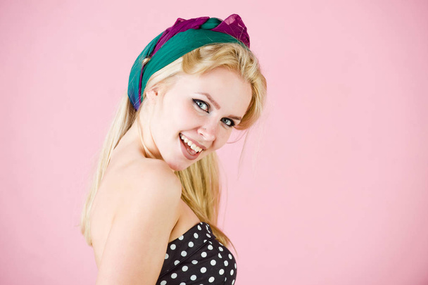 pretty happy woman with turban and makeup on pink, pinup - Foto, Bild