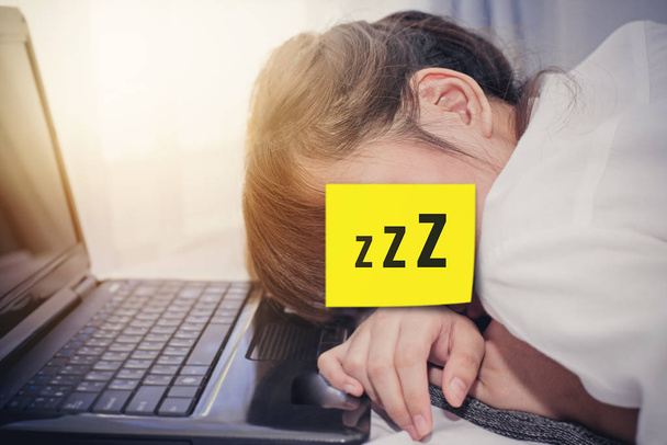 Asian woman sleeping on her laptop - Zdjęcie, obraz