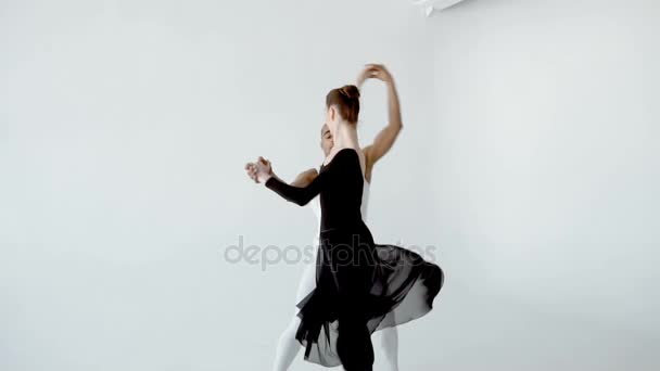 Guy in white and girl in black doing ballet in white dance studio slow motion 120fps. - Metraje, vídeo
