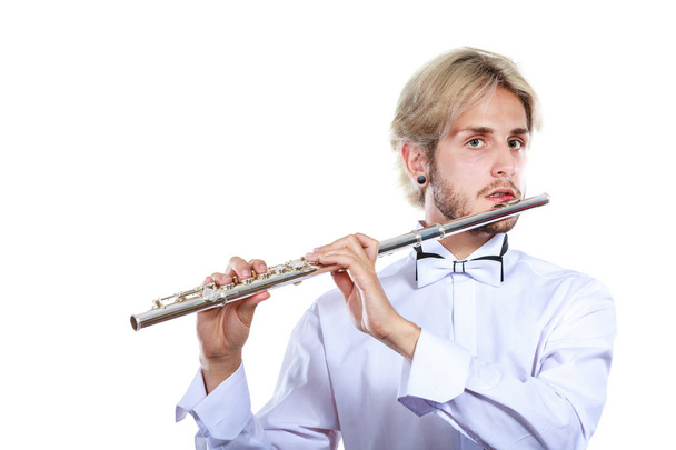 Male flutist playing his flute - Zdjęcie, obraz