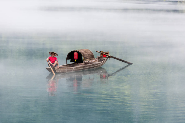 A fisherman of the Misty Small Dongjiang - Photo, Image