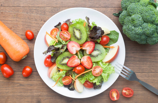 Fresh salad with strawberries, kiwi, tomatoes and apples, top vi - Photo, image