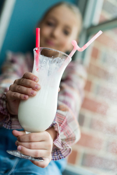 girl holding glass of milkshake - Φωτογραφία, εικόνα