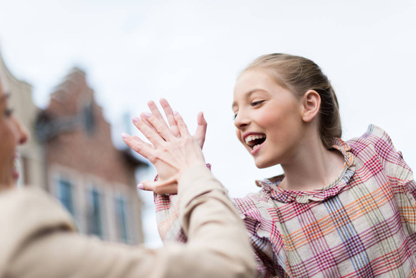 Daughter giving high five to mother - Photo, Image