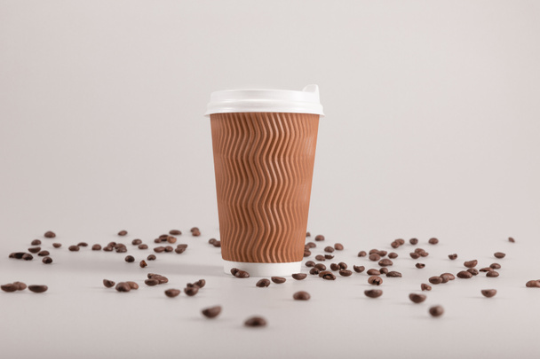 taza desechable con granos de café
 - Foto, imagen