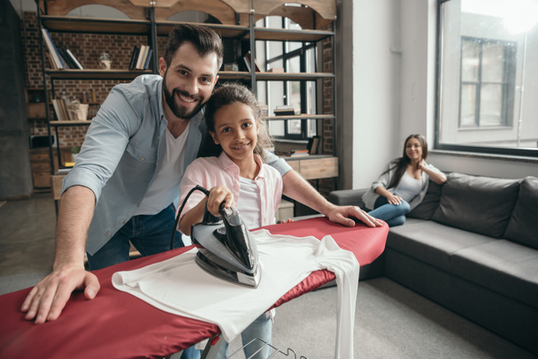 father with daughter ironing clothes - Foto, Imagen