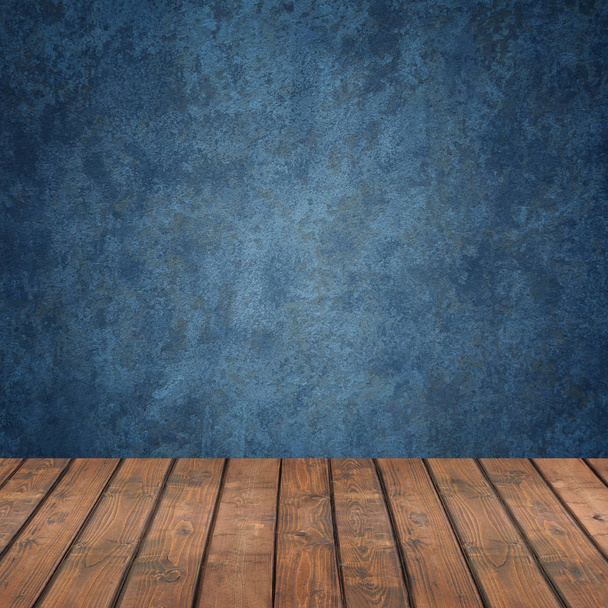 Empty wooden flooring against a blue wall - Фото, зображення