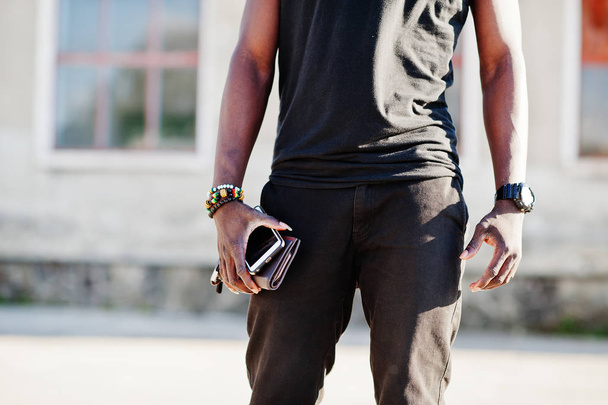 Portrait of a handsome african american guy in black muscle shir - Fotografie, Obrázek
