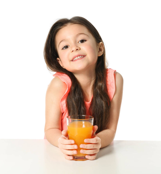 Cute little girl with glass of juice - Фото, изображение