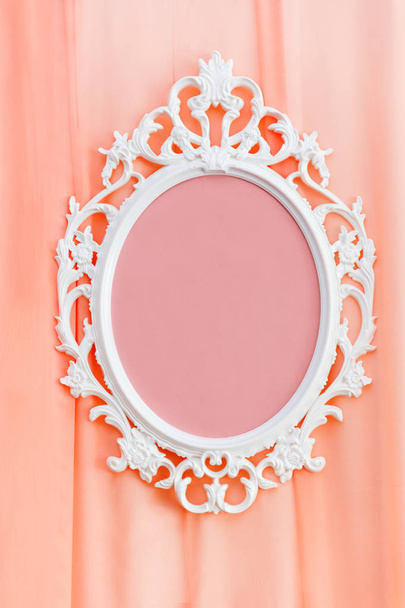 Decorative white frame on coral fabric. Element of party decoration. - Фото, изображение