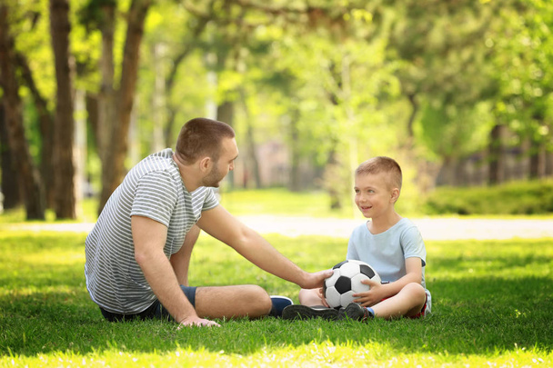 Father and son playing with soccer ball  - Foto, afbeelding